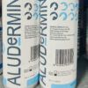 Detalle del envase de aludermin spray con código de barras e información del fabricante.